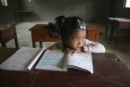 A student looks out of a classroom during a break at a primary school in a rural village of Gutian county
